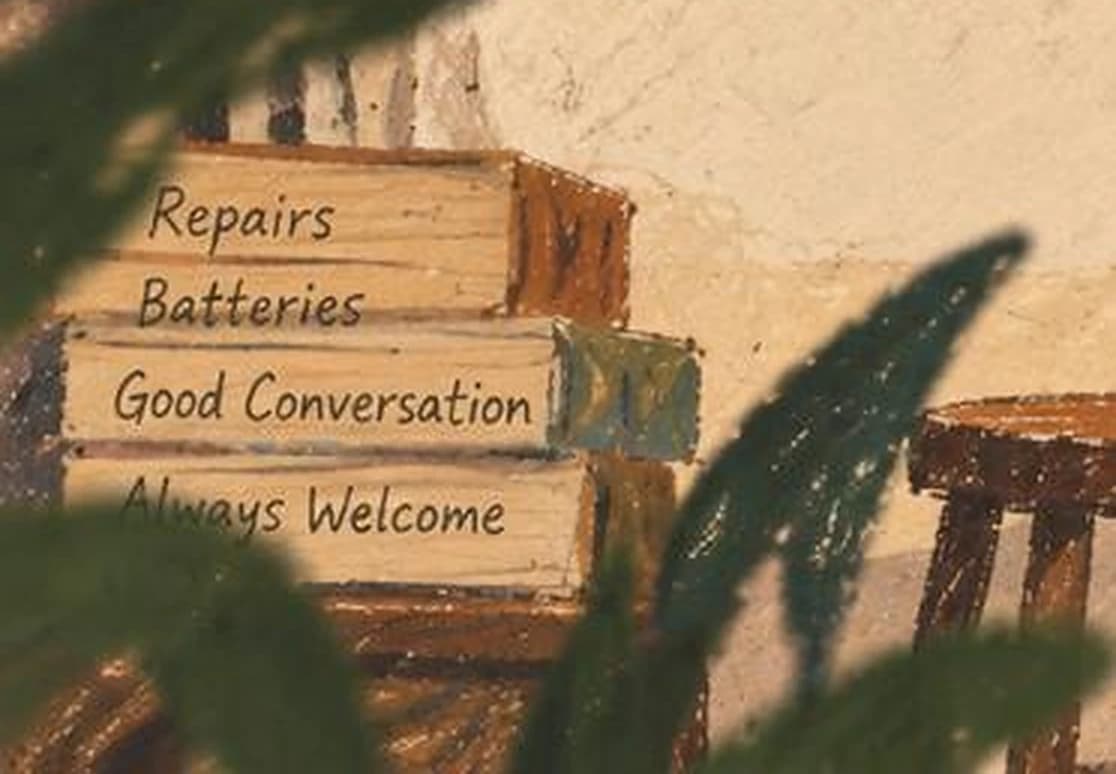 A hand-lettered sign at the shop reading repairs, batteries, good conversation, always welcome